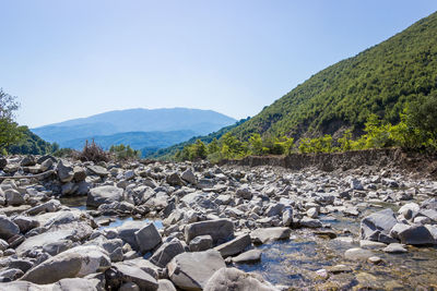 Scenic view of mountains against clear blue sky