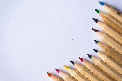 Close-up of colored pencils against white background