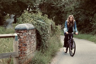 Full length of woman riding bicycle