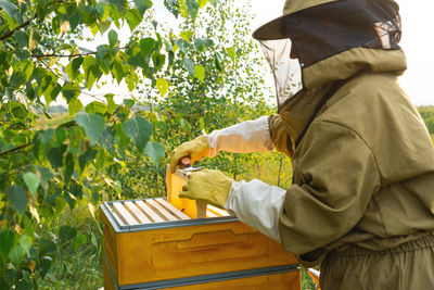 Rear view of man standing against plants