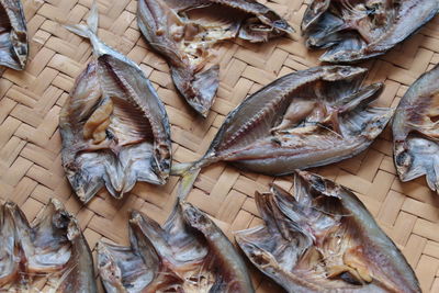 High angle view of dried fish on wicker plate