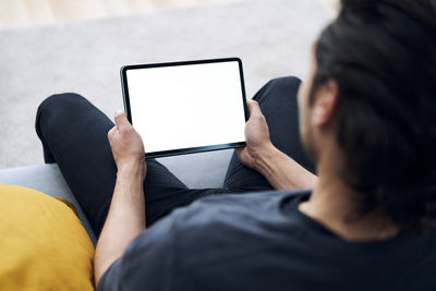 Midsection of man using mobile phone