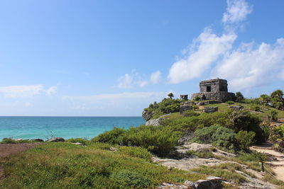 Old ruins at sea shore against sky
