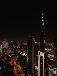 High angle view of illuminated buildings against sky at night