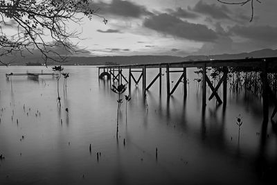 Pier on lake against sky