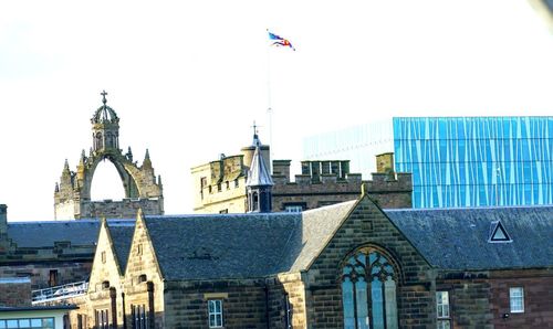 Buildings in city against clear sky