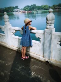 Full length of woman standing by railing