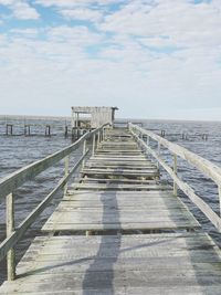 Pier over sea against sky