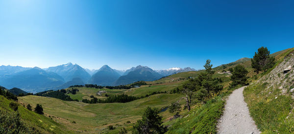 Scenic view of mountains against clear blue sky