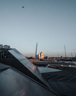 Airplane flying over buildings in city