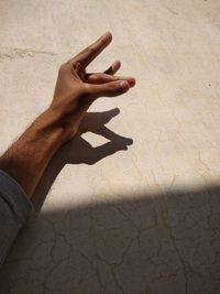Shadow of person hand on wall