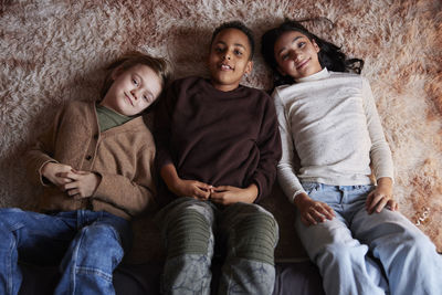 Portrait of children lying on floor