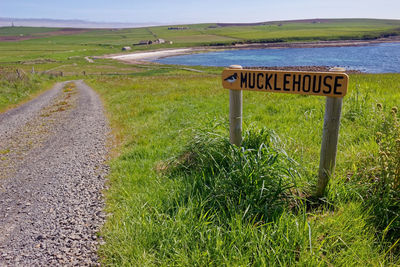 Road sign on field