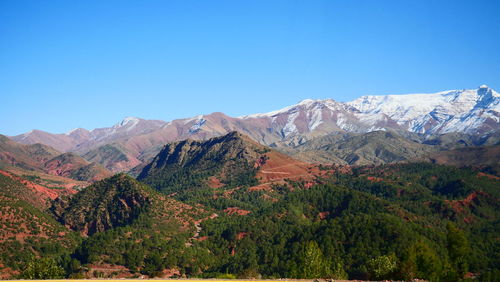 Scenic view of mountains against clear blue sky