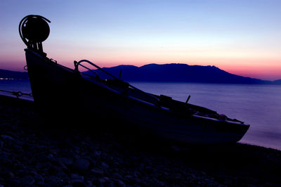 Boat in sea at sunset