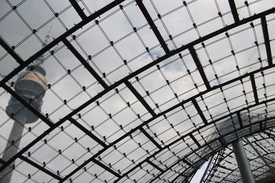 Low angle view of skylight in building against sky
