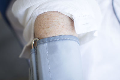 Close-up of person wearing blood pressure gauge