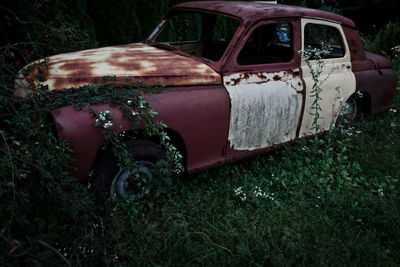 Abandoned car on field