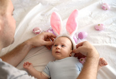 Portrait of cute baby boy lying on bed