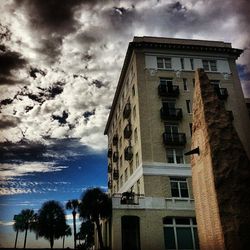 Low angle view of building against cloudy sky