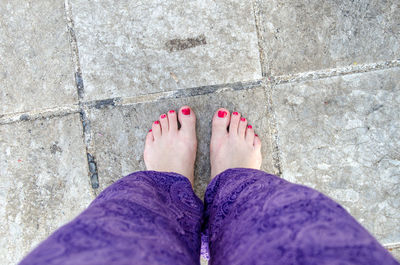 Low section of woman standing on tiled floor