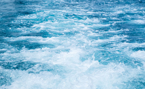 Blue background water glistening swimming pool