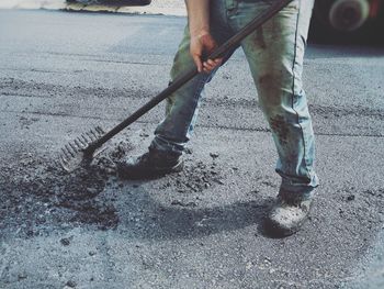 Low section of worker working on road