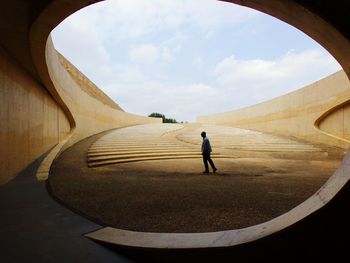 Rear view of person standing in sky