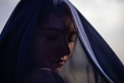 Close-up of woman covered with navy blue textile