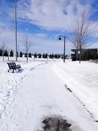 Snow covered street against sky