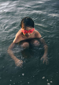 High angle view of boy swimming in lake