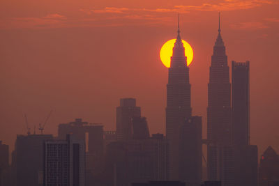 Modern buildings in city during sunset