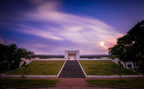 View of footpath against cloudy sky