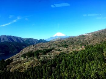 Scenic view of mountains against blue sky