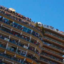 Low angle view of buildings against clear blue sky