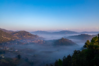 High angle view of trees and mountains against sky