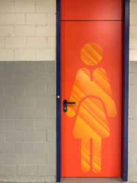 Close-up of orange door on wall