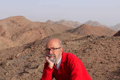 Senior man with red shirt in the desert 