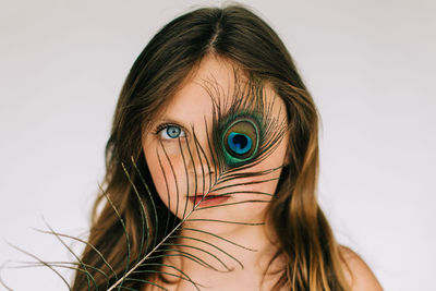 Close-up portrait of woman against white background