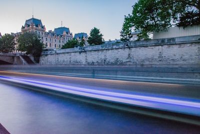 Light trails on road against buildings in city