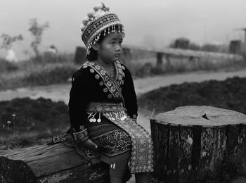 Cute girl wearing traditional clothing while looking away outdoors