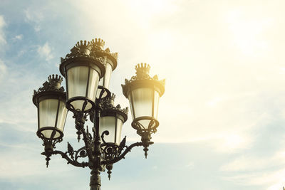 Low angle view of street light against cloudy sky