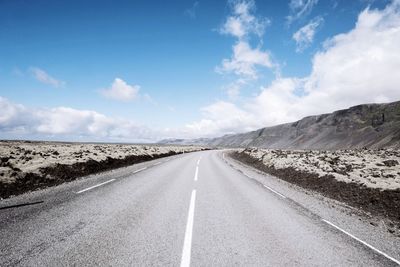 Road passing through landscape against sky