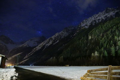 Scenic view of mountains against sky at night