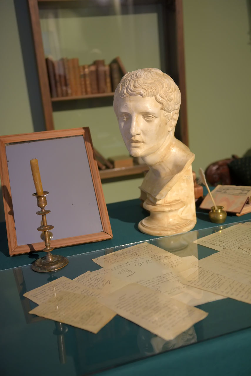 CLOSE-UP OF SCULPTURE ON TABLE AT HOME