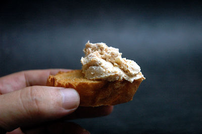 Close-up of hand holding pate on toast