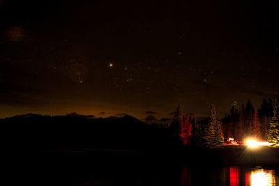 Scenic view of lake against sky at night