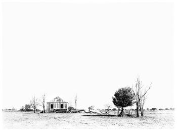 Built structure on snow covered landscape against clear sky