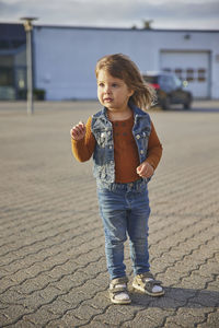 Full length of boy standing on street