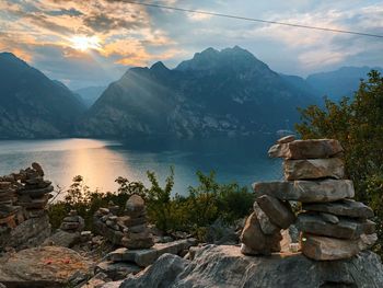 Stack of rocks by mountain against sky